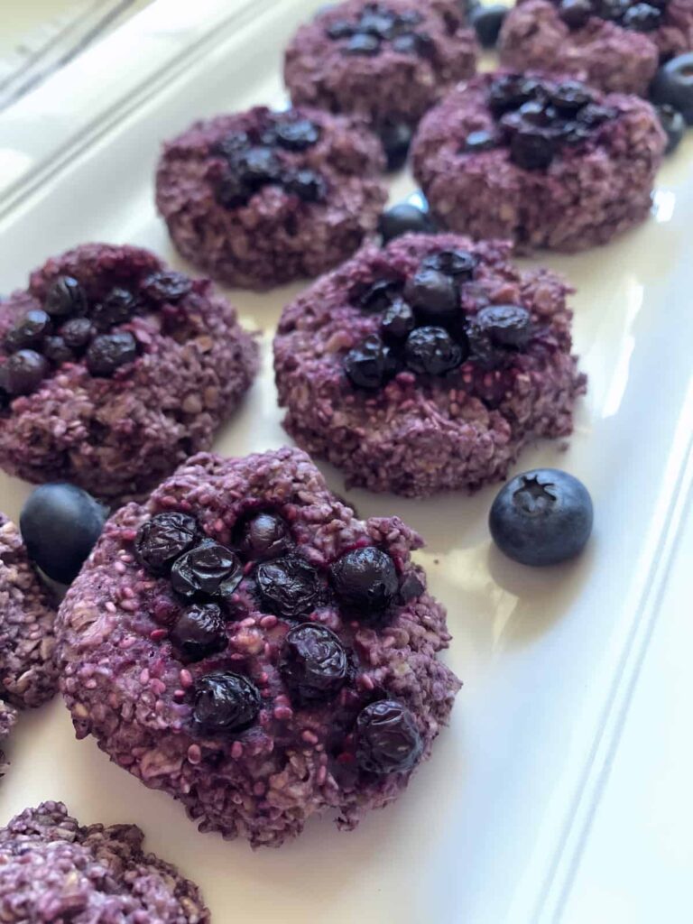 Purple Blueberry Chia Cookies with fresh blueberries on a white plate