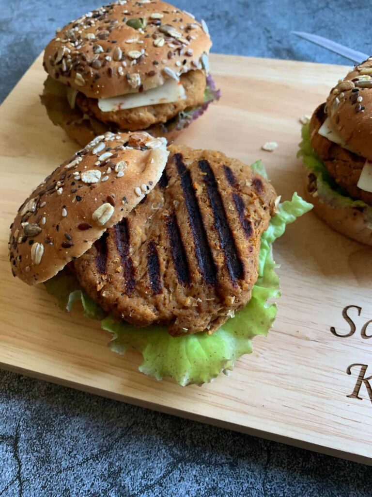 vegan turkey burger with grill marks on a cutting board
