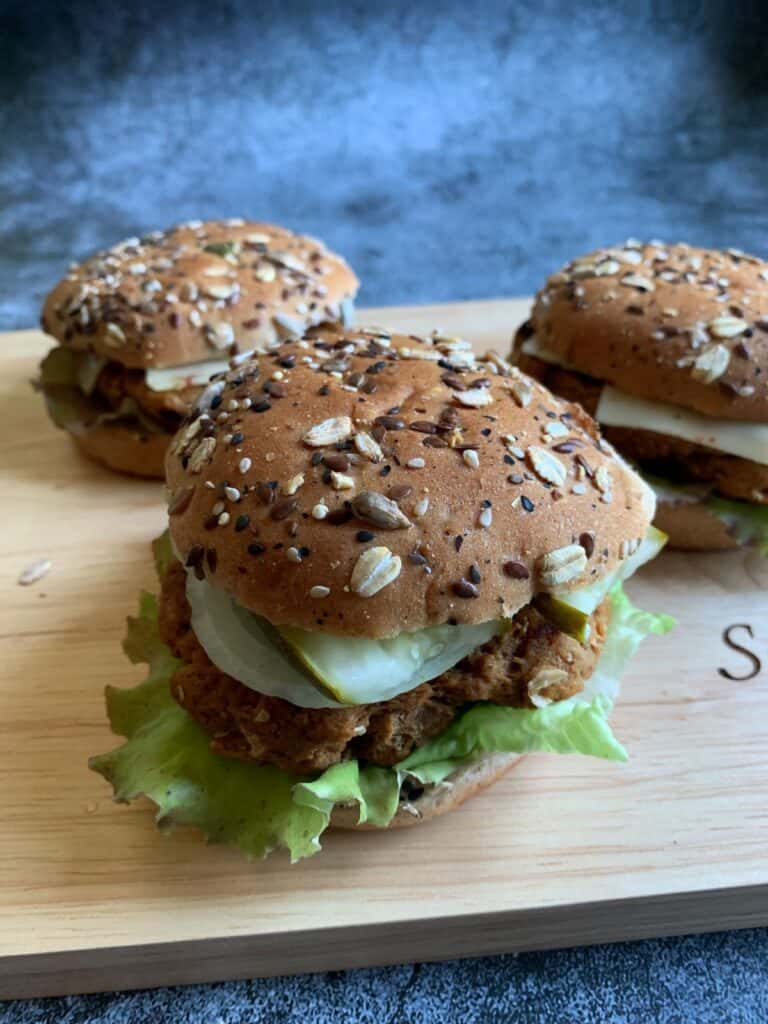 vegan turkey burgers on a wooden cutting board