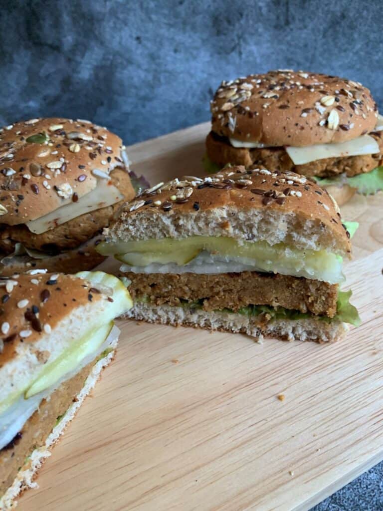 vegan turkey burger cut in half on a cutting board