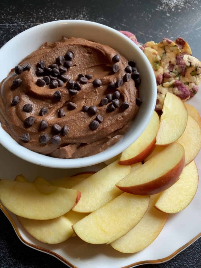 chocolate dessert hummus topped with chocolate chips served with apple slices