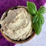 vegan tofu ricotta in a ceramic bowl topped with fresh basil