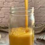vegan cheese sauce pouring into a mason jar