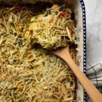 vegan breakfast casserole in a blue and white dish with wooden spoon