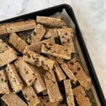 frozen chocolate chip oatie bars on a baking sheet with white background