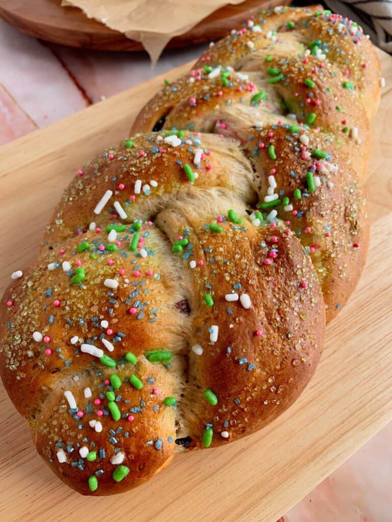 Vegan Braided Easter Bread with sprinkles on a cutting board