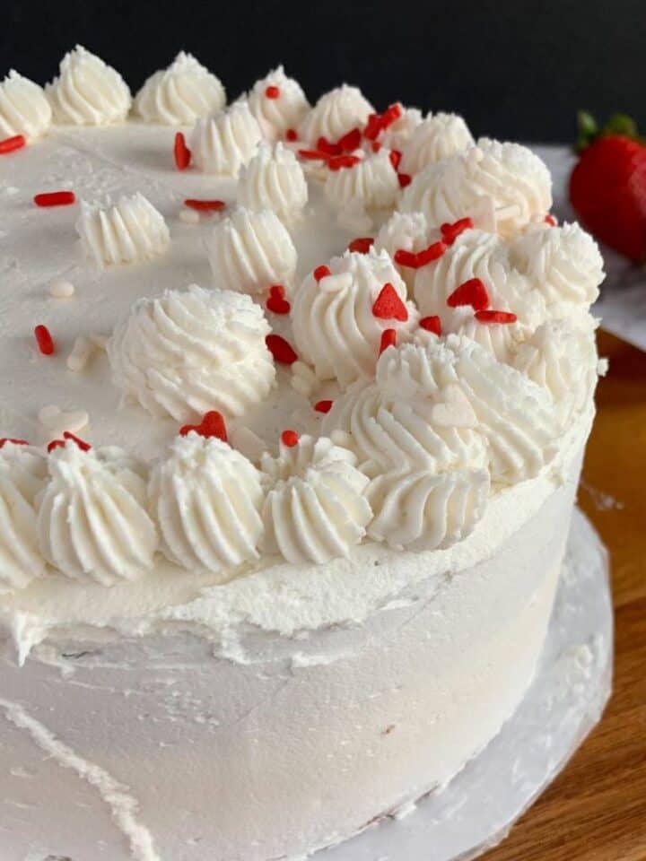 White buttercream frosting used to decorate a two layer cake