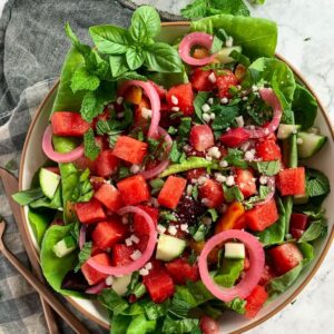 mixed watermelon beet salad in a white salad dish