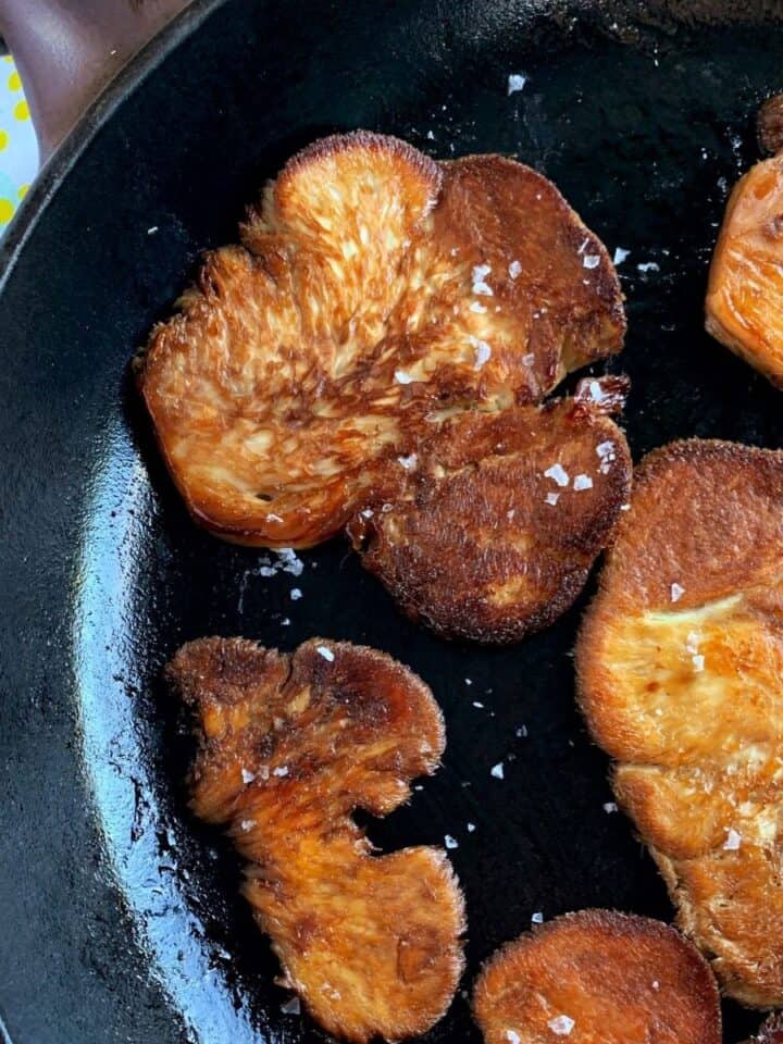 pan fried lion's mane mushrooms on a cast iron skillet