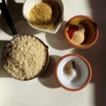 Ingredients for panko mix laid out in bowls: panko, salt, nutritional yeast, garlic, onion and smoked paprika.
