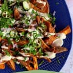 Pinterest image of loaded sweet potato fries with soy curls and vegan sour cream.