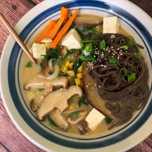 Soba shitake soup in a bowl with carrots and tofu.