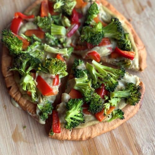 Lentil & cauliflower pizza sliced and ready to eat.