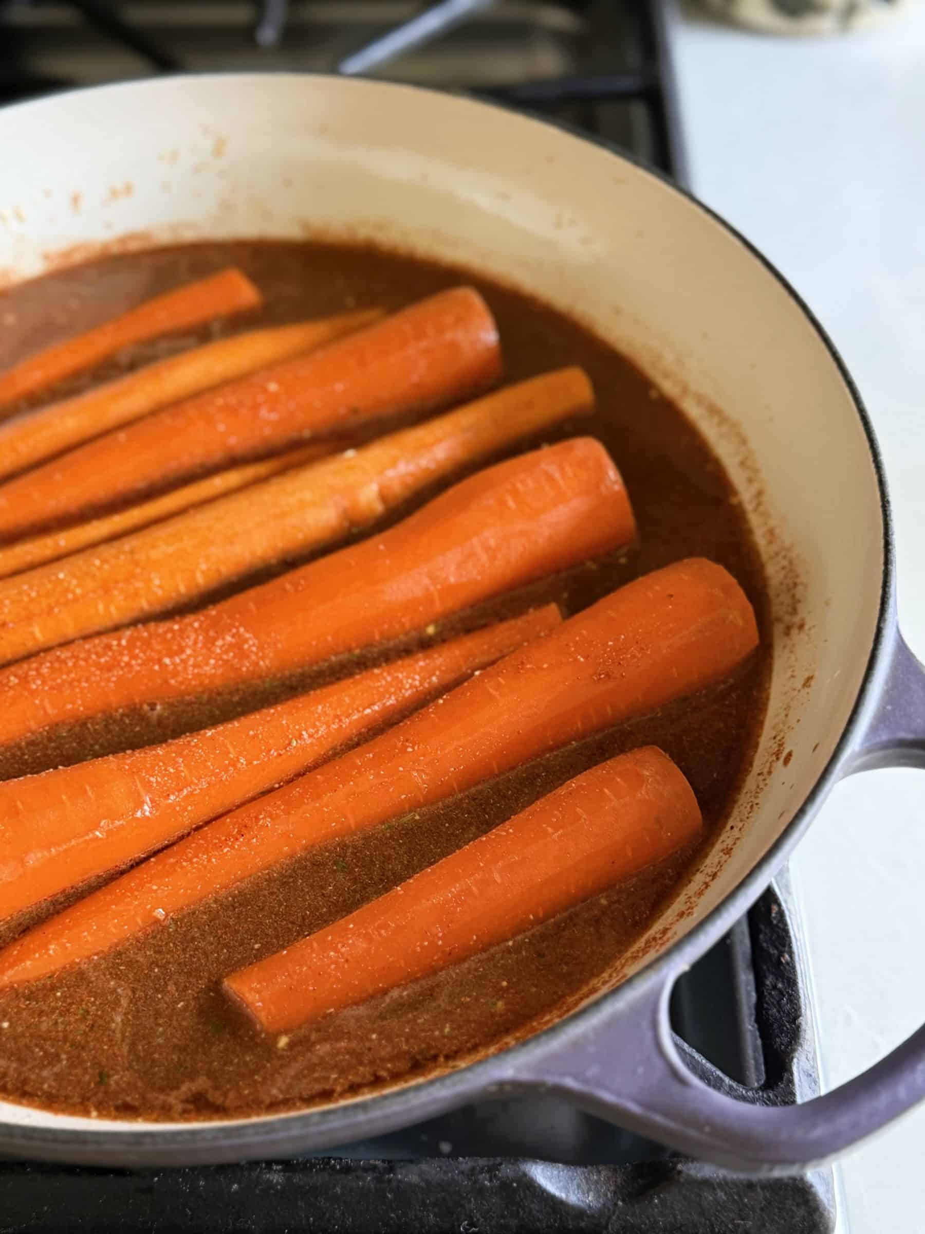 Carrots and cooking liquid in skillet.